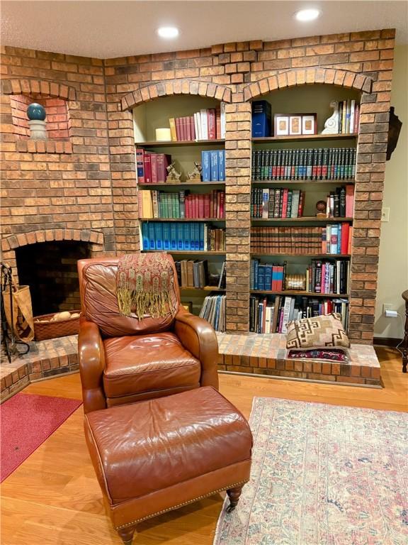 2236 Seneca Dr, Charleston, IL 61920 - living area with a brick fireplace and wood finished floors
