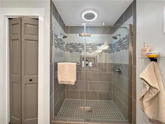 bathroom featuring a shower stall and a closet