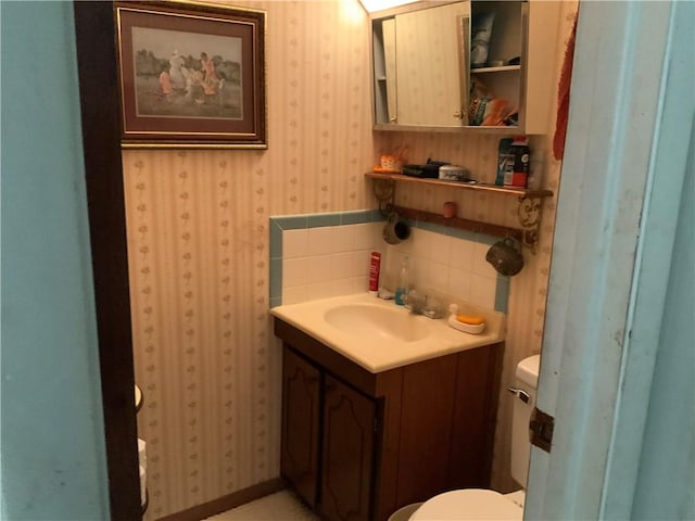 603 W English St, Danville, IL 61832 - half bath with toilet, wallpapered walls, and vanity