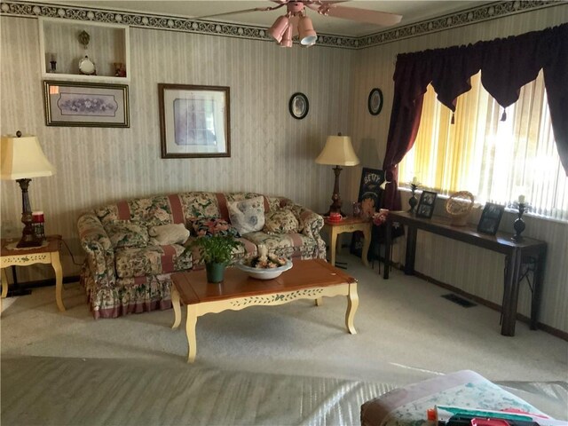 603 W English St, Danville, IL 61832 - carpeted living area with wallpapered walls and ceiling fan