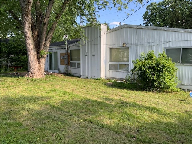 603 W English St, Danville, IL 61832 - view of home's exterior with a yard, board and batten siding, and a chimney