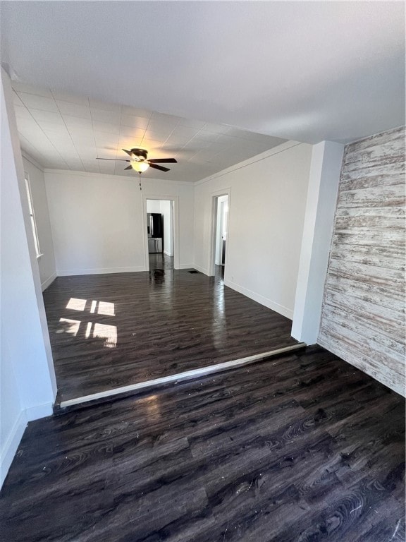 unfurnished room with dark hardwood / wood-style floors, ceiling fan, and crown molding