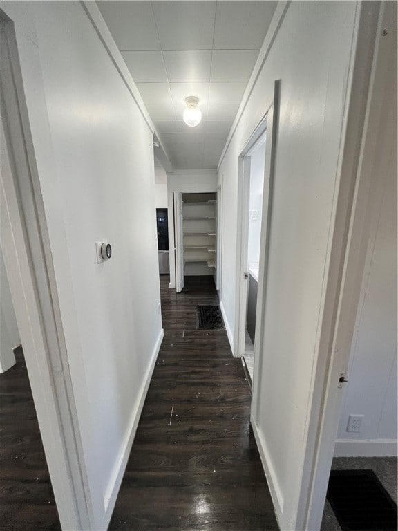 corridor with dark wood-type flooring