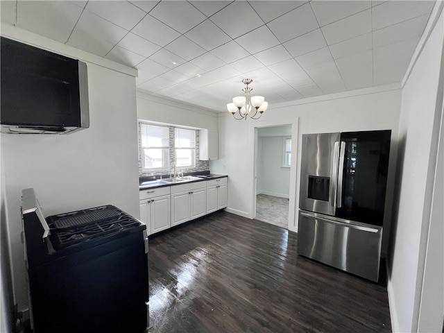 kitchen with white cabinets, crown molding, stainless steel fridge, dark hardwood / wood-style flooring, and a chandelier