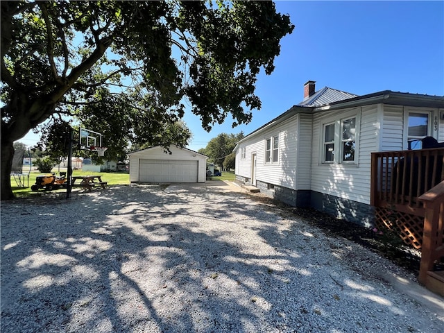 view of side of property featuring an outbuilding and a garage