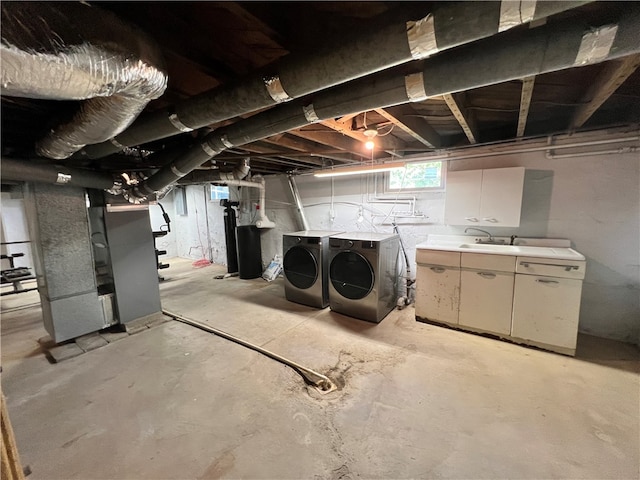 basement with separate washer and dryer, sink, and heating unit