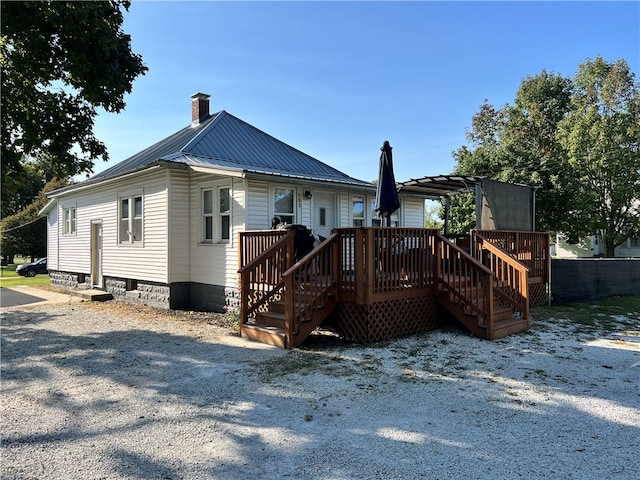 back of house with a deck