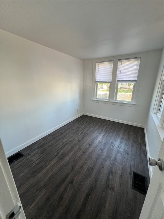 empty room with dark hardwood / wood-style floors