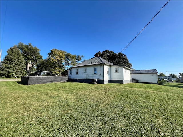 view of property exterior with a lawn