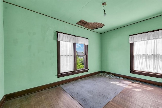 426 W Madison St, Paris, IL 61944 - empty room featuring baseboards and wood finished floors
