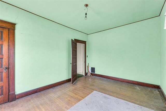 426 W Madison St, Paris, IL 61944 - unfurnished room with wood finished floors and baseboards
