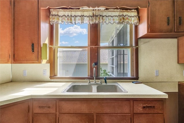 426 W Madison St, Paris, IL 61944 - kitchen featuring a sink, light countertops, and brown cabinets