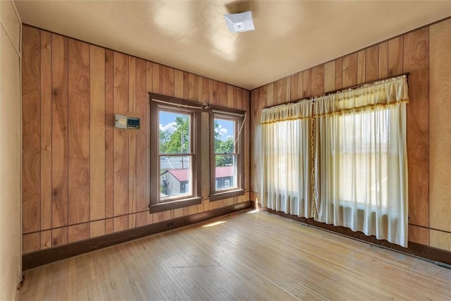 426 W Madison St, Paris, IL 61944 - empty room with hardwood / wood-style flooring and wooden walls