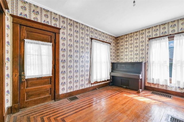 426 W Madison St, Paris, IL 61944 - foyer entrance featuring wood finished floors, baseboards, and wallpapered walls