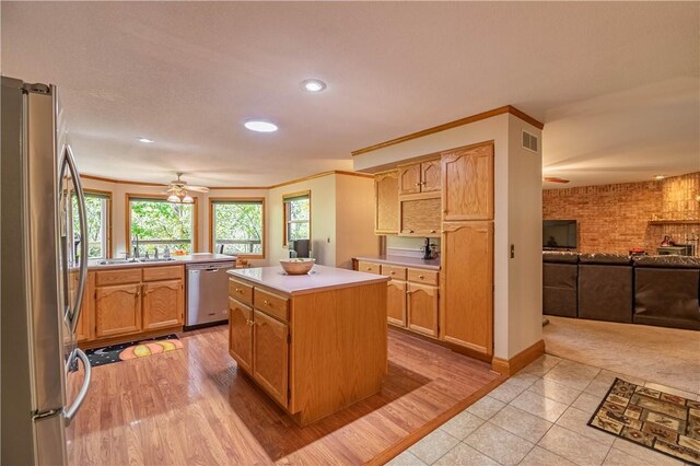 5353 E Reas Bridge Rd, Decatur, IL 62521 - kitchen with appliances with stainless steel finishes, open floor plan, a sink, recessed lighting, and light countertops