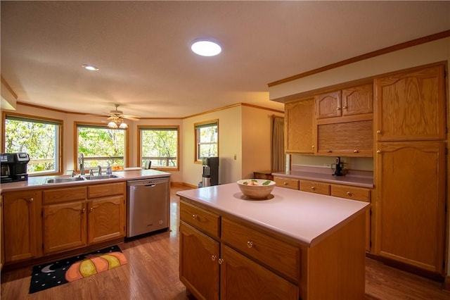 5353 E Reas Bridge Rd, Decatur, IL 62521 - kitchen with stainless steel dishwasher, a sink, light wood-type flooring, light countertops, and ornamental molding