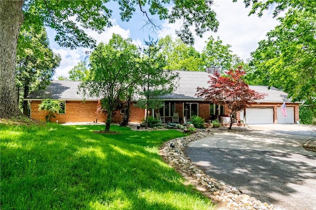 5353 E Reas Bridge Rd, Decatur, IL 62521 - ranch-style home with concrete driveway, a garage, brick siding, and a front yard
