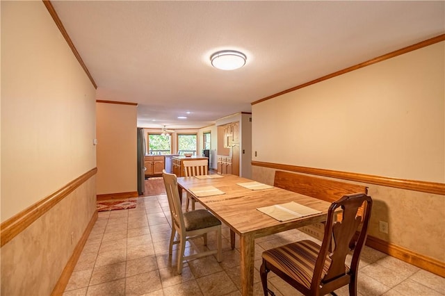 5353 E Reas Bridge Rd, Decatur, IL 62521 - dining space with ornamental molding, light tile patterned flooring, wainscoting, and baseboards