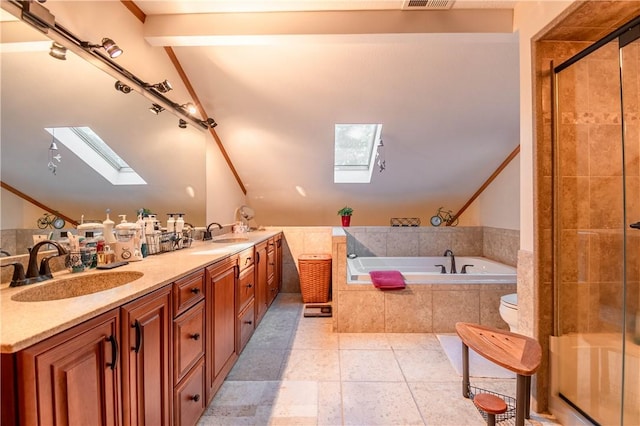 5353 E Reas Bridge Rd, Decatur, IL 62521 - full bathroom featuring a skylight, vaulted ceiling, a garden tub, tile patterned floors, and a stall shower