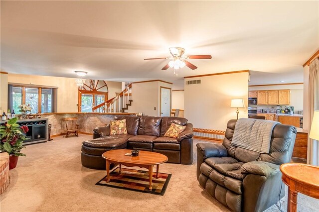 5353 E Reas Bridge Rd, Decatur, IL 62521 - living area with light colored carpet, ceiling fan, and stairs