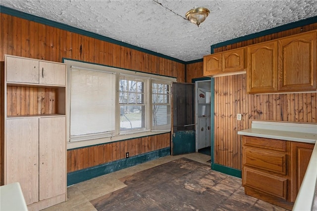 311 Lafayette St, Newton, IL 62448 - kitchen featuring light countertops, wood walls, brown cabinets, and crown molding