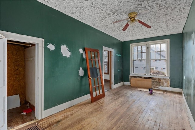 311 Lafayette St, Newton, IL 62448 - interior space with wood-type flooring, baseboards, ceiling fan, and a textured ceiling