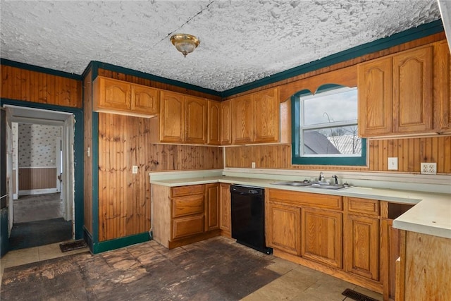 311 Lafayette St, Newton, IL 62448 - kitchen with a sink, brown cabinetry, black dishwasher, wooden walls, and light countertops