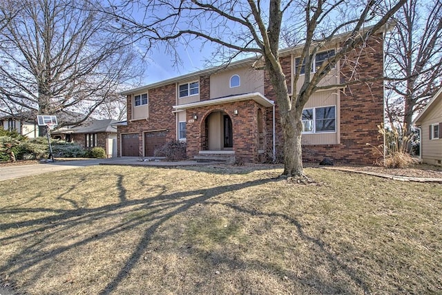 view of front facade with a front yard, brick siding, driveway, and an attached garage