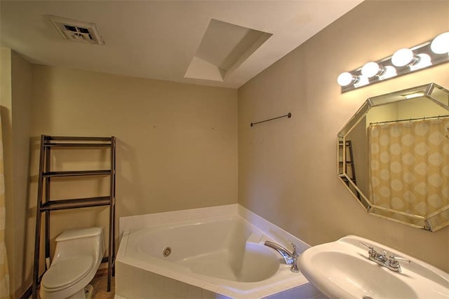 full bathroom with a garden tub, a sink, visible vents, and toilet