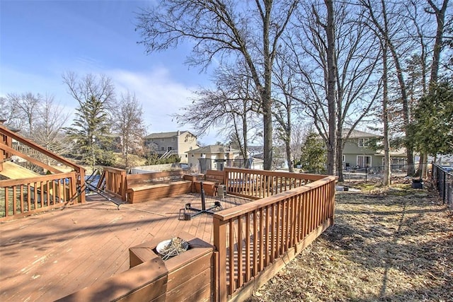 wooden terrace with a residential view and fence