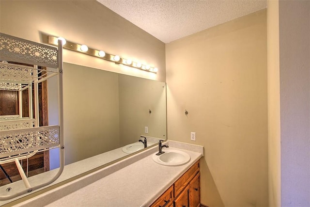 bathroom with a textured ceiling and vanity