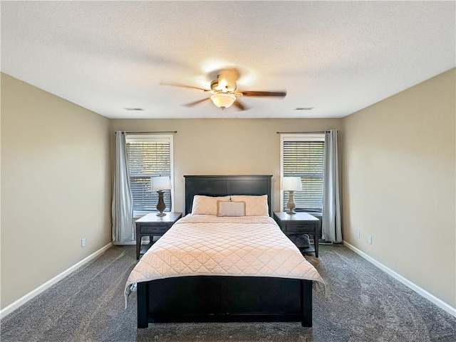 bedroom featuring dark carpet, a textured ceiling, baseboards, and ceiling fan