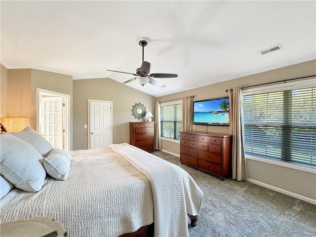 carpeted bedroom featuring vaulted ceiling, ceiling fan, visible vents, and baseboards