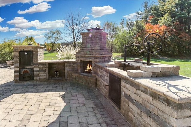 view of patio / terrace with a lit fireplace