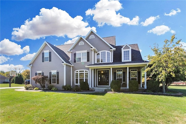 view of front of house featuring covered porch and a front yard