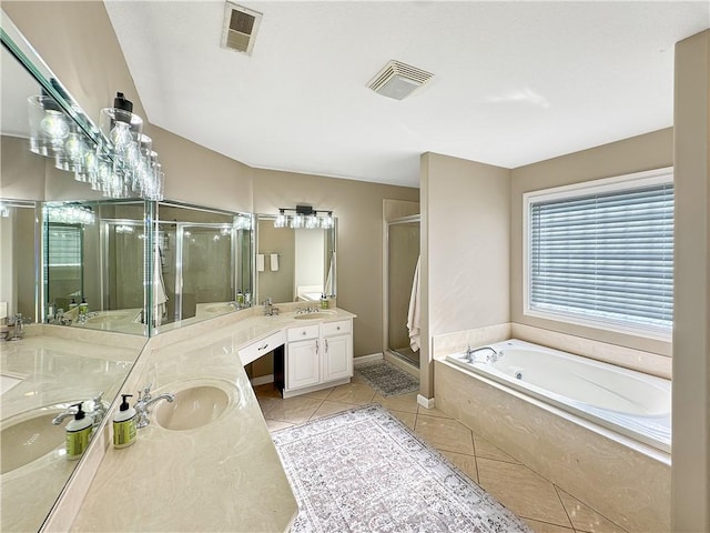 bathroom featuring tile patterned flooring, visible vents, a sink, and a shower stall