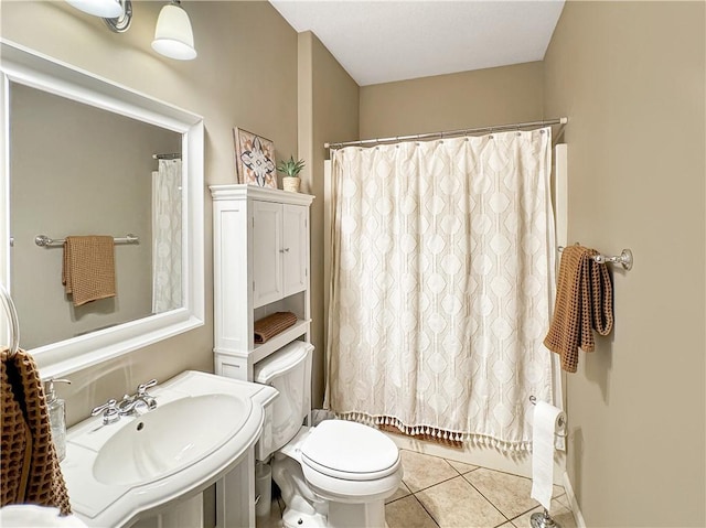 full bathroom with a sink, toilet, and tile patterned floors