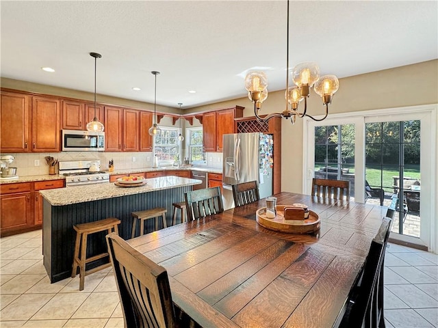 dining room with light tile patterned floors, recessed lighting, and an inviting chandelier