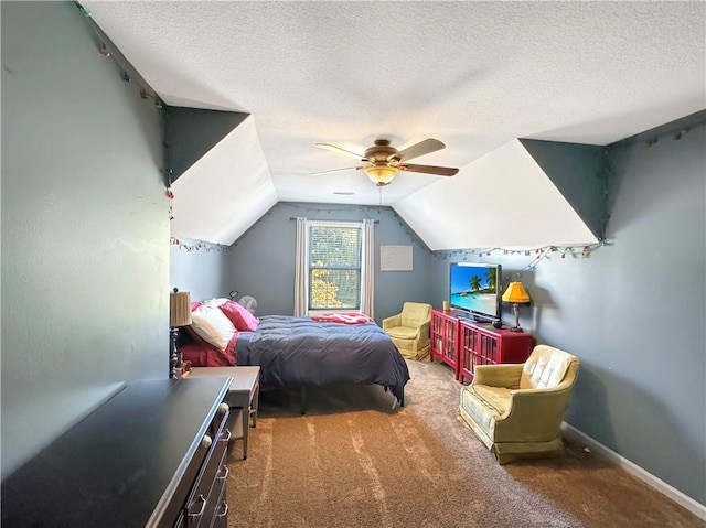 bedroom with carpet floors, a ceiling fan, vaulted ceiling, a textured ceiling, and baseboards