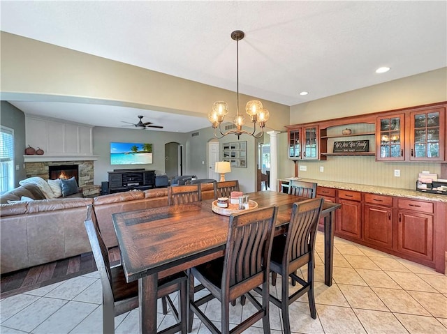 dining room featuring arched walkways, ceiling fan, recessed lighting, and light tile patterned floors