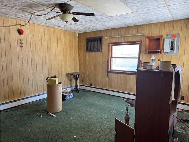 exercise area with a baseboard radiator, carpet flooring, electric panel, and wooden walls