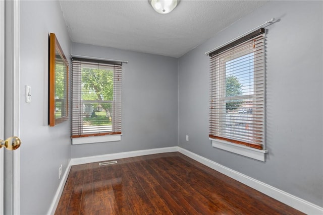 510 N Merchant St, Effingham, IL 62401 - spare room featuring wood finished floors, baseboards, and a textured ceiling