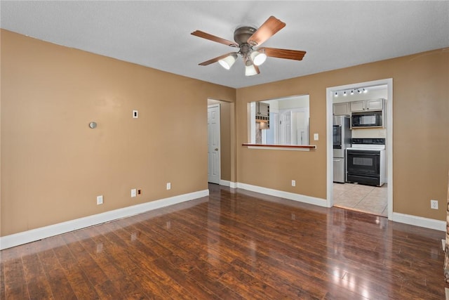 510 N Merchant St, Effingham, IL 62401 - unfurnished living room featuring a ceiling fan, baseboards, and wood finished floors