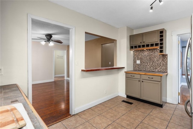 510 N Merchant St, Effingham, IL 62401 - kitchen featuring gray cabinets, tasteful backsplash, ceiling fan, and baseboards