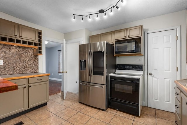 510 N Merchant St, Effingham, IL 62401 - kitchen with stainless steel fridge, range with electric cooktop, black microwave, tasteful backsplash, and light tile patterned floors