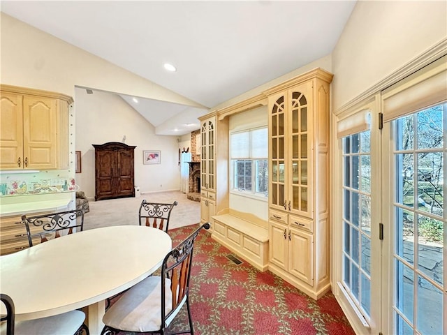 508 Deere Run Ln, Casey, IL 62420 - dining space with a wealth of natural light, visible vents, carpet floors, and vaulted ceiling