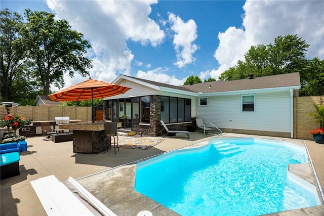 1003 Flame Ave, Effingham, IL 62401 - view of swimming pool featuring a fenced backyard, a patio, and a sunroom