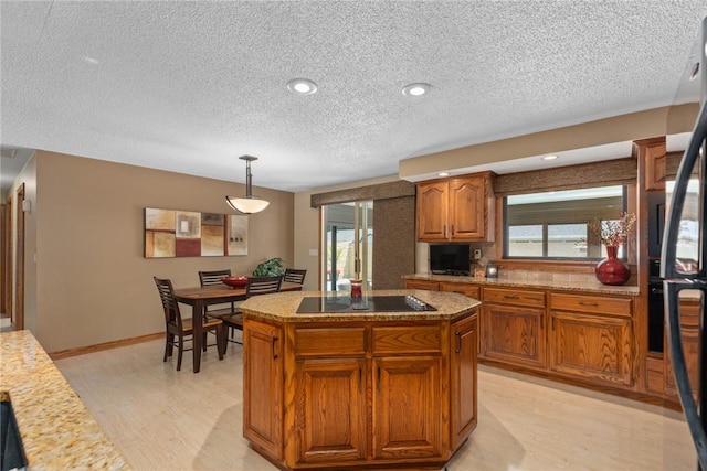 1003 Flame Ave, Effingham, IL 62401 - kitchen featuring black appliances, a textured ceiling, brown cabinets, plenty of natural light, and pendant lighting