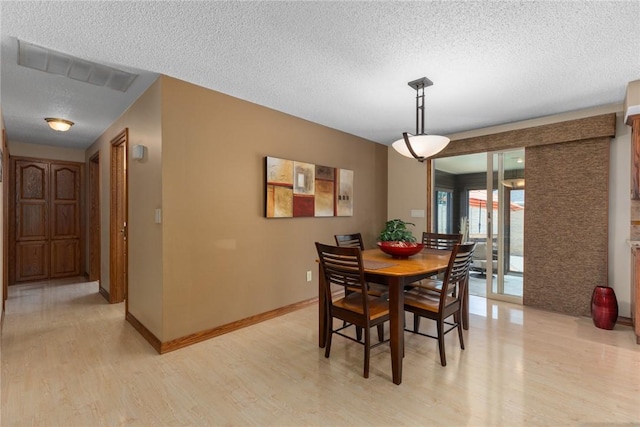 1003 Flame Ave, Effingham, IL 62401 - dining area with light wood-style floors and a textured ceiling