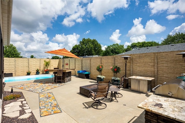 1003 Flame Ave, Effingham, IL 62401 - fenced backyard featuring area for grilling, a patio area, a fire pit, and an outdoor bar